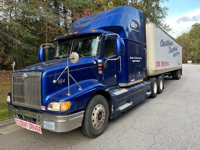Blue CDL training truck parked on the lot